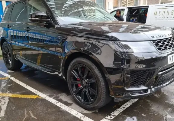 Glossy black Range Rover freshly detailed by Medusa Auto Detailing, parked in a marked bay.