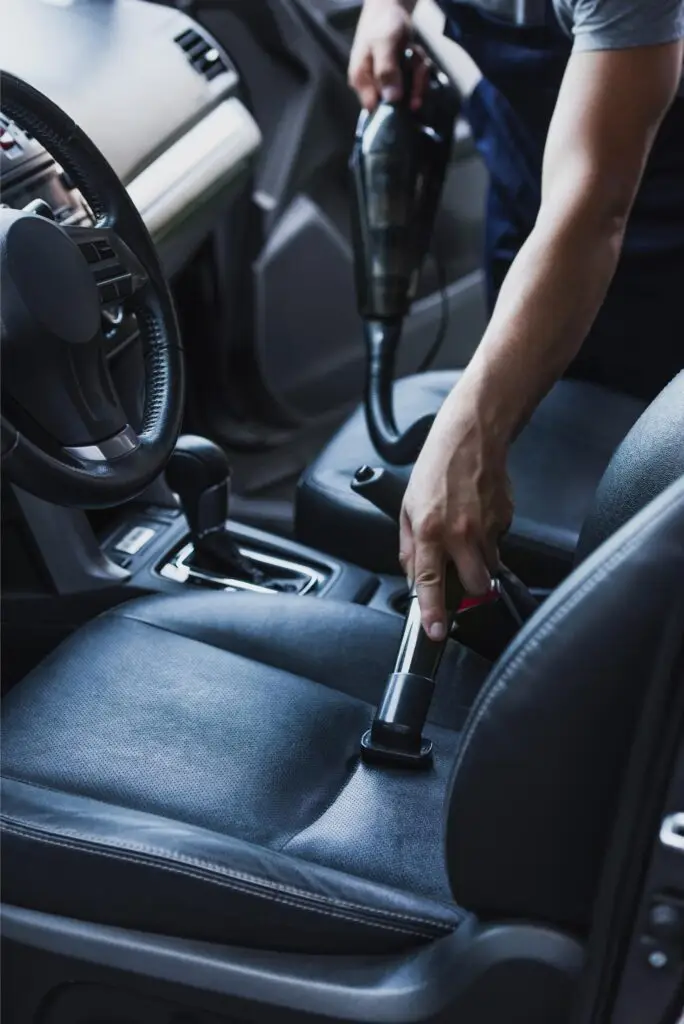 partial view of car cleaner vacuuming drivers seat 2024 11 17 07 05 45 utc 1