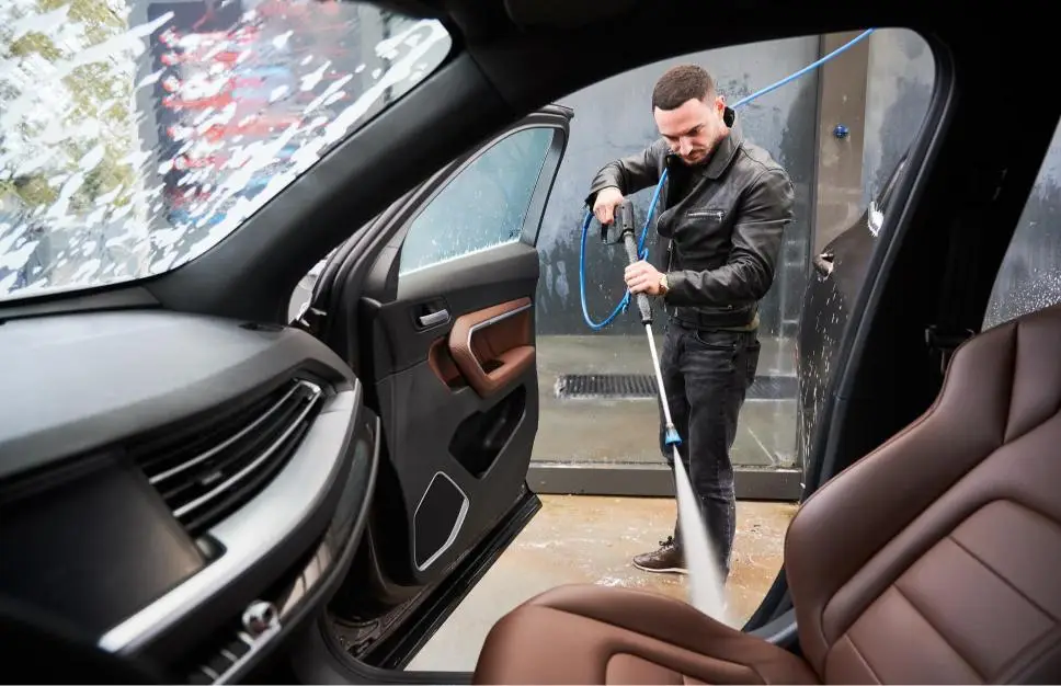 young man washing car on carwash station outdoor 2023 11 27 05 27 22 utc 1 1